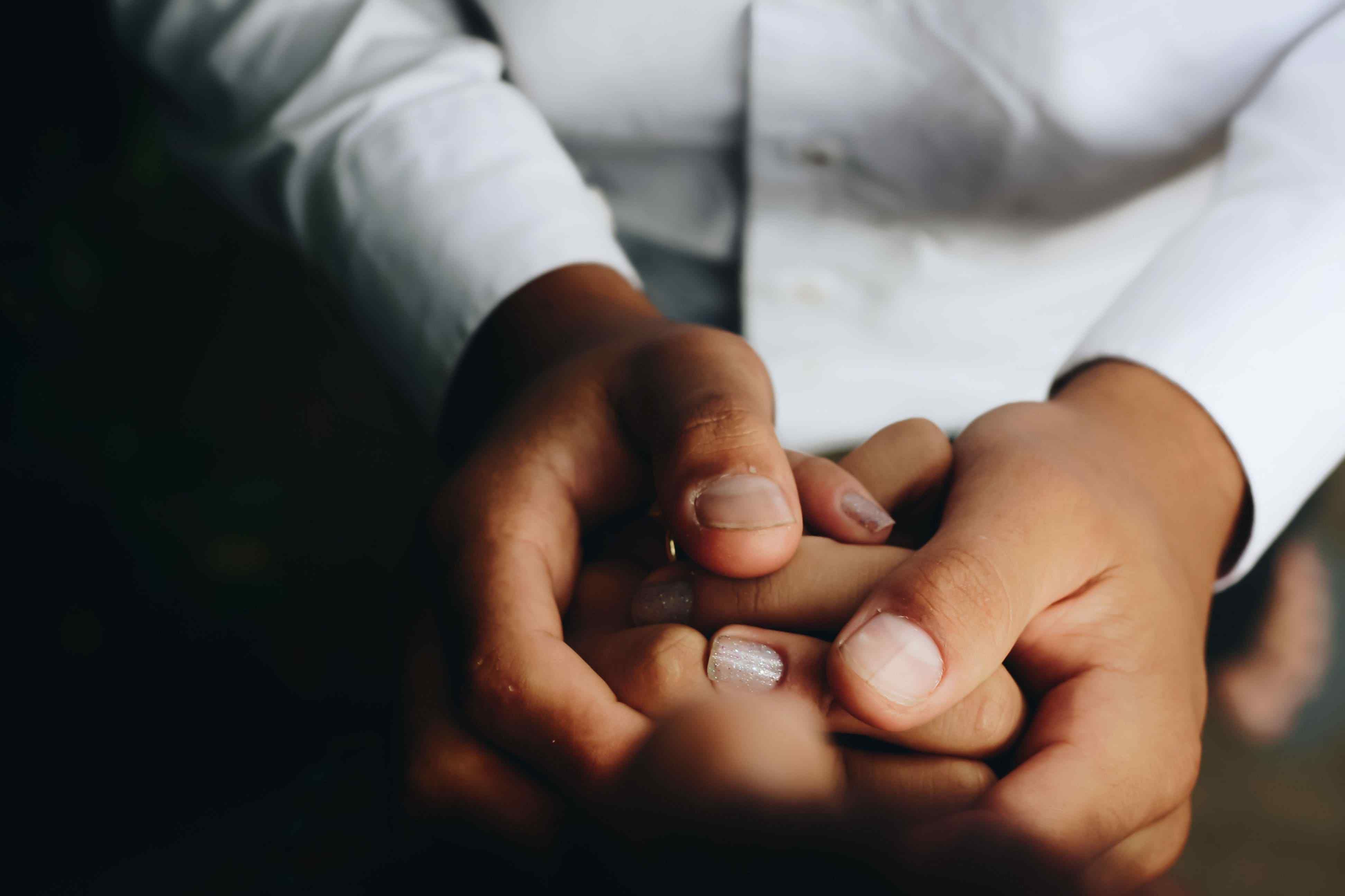 Boy holding mother's hand